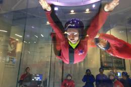 A member of Best Buddies takes flight in the wind tunnel. (WTOP/Noah Frank)
