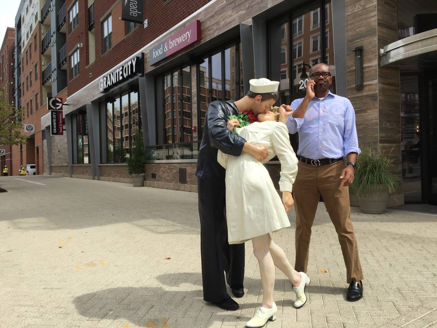 This statue on display at National Harbor depicts an iconic Times Square photo taken Aug. 14, 1945 upon news of the Japanese surrender that ended World War II. (WTOP/Kristi King)