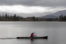This photo taken Nov. 13, 2009 shows a man paddling a boat on Mirror Lake  in Lake Placid, N.Y., Sat.   (AP Photo/Mike Groll)