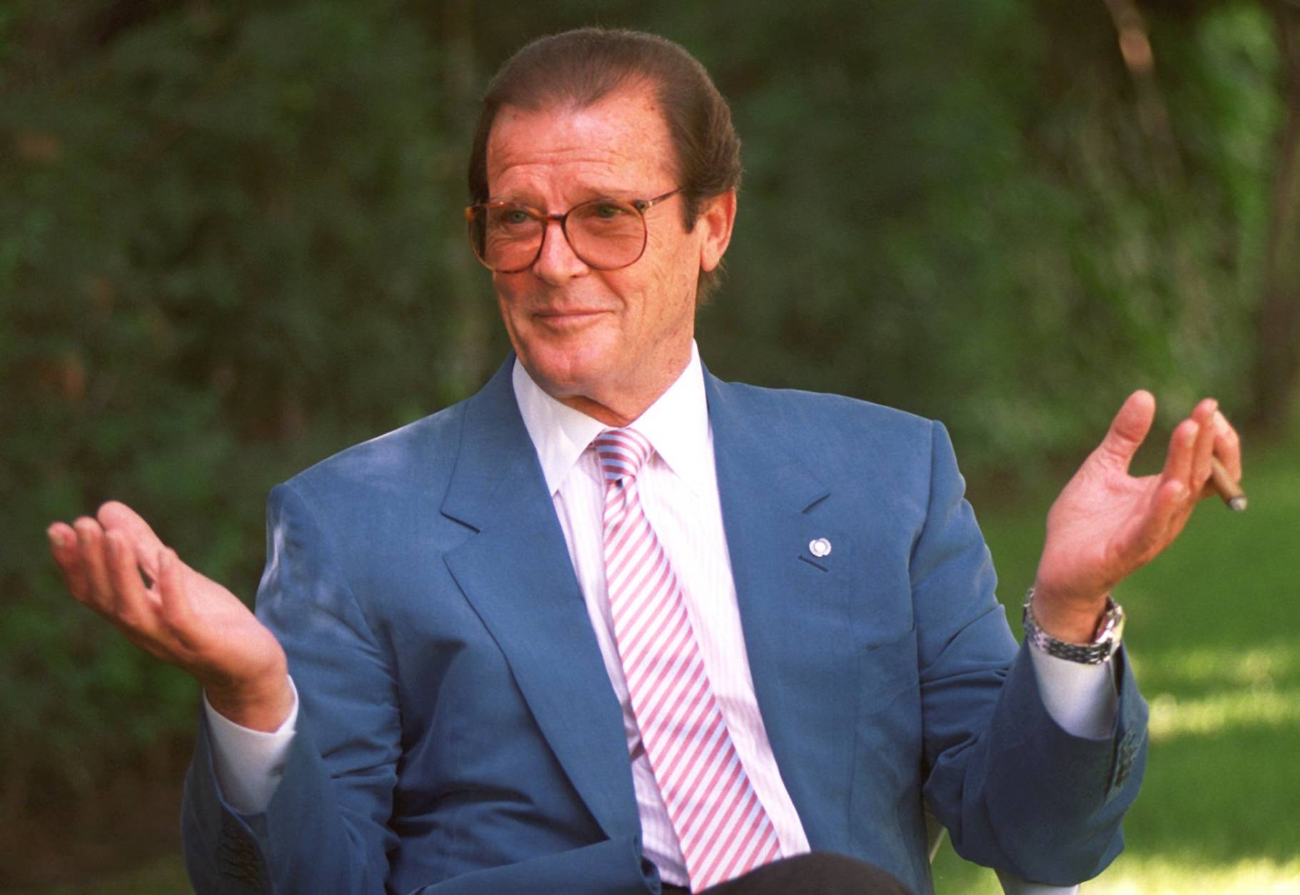 British actor Roger Moore gestures during an interview in the Studio City section of Los Angeles, April 22, 1996. (AP Photo/Chris Pizzello)