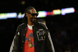 Rapper Snoop Dog walks on the court during the NBA All Star basketball game, Sunday, Feb. 16, 2014, in New Orleans. (AP Photo/Gerald Herbert)