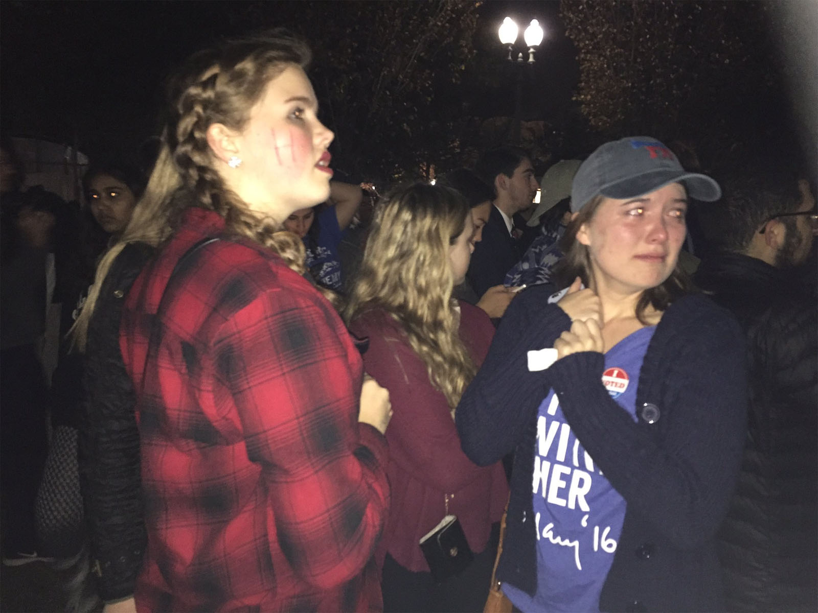 Tearful members of a crowd gathered in front of the White House. (WTOP/Michelle Basch)