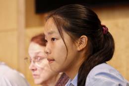 Fifteen-year-old Council member for a day Angela Wu listens to testimony from the dais. (WTOP/Kate Ryan)