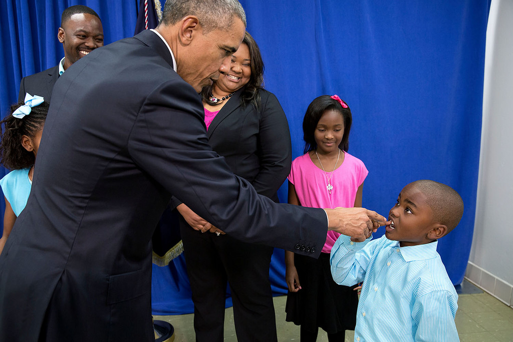 President Barack Obama talks with a young boy about his missing tooth, following a roundtable on consumer protection issues at Lawson State Community College in Birmingham, Ala., March 26, 2015. (Official White House Photo by Pete Souza)