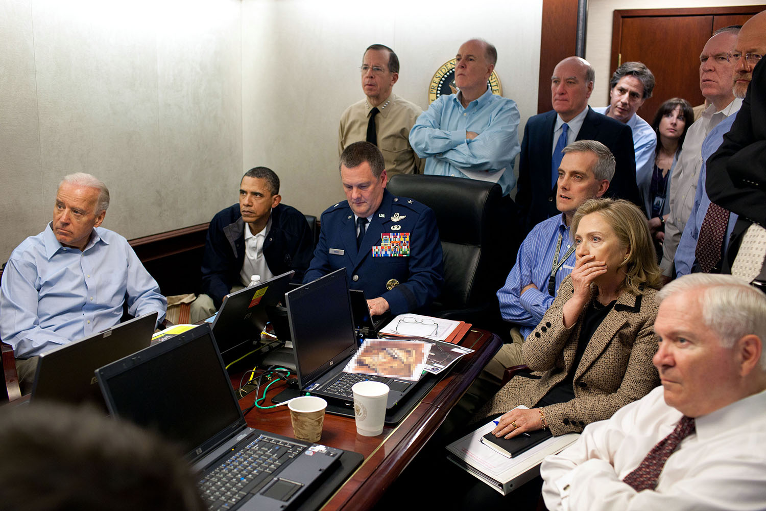 May 1, 2011
"Much has been made of this photograph that shows the President and Vice President and the national security team monitoring in real time the mission against Osama bin Laden. Some more background on the photograph: The White House Situation Room is actually comprised of several different conference rooms. The majority of the time, the President convenes meetings in the large conference room with assigned seats. But to monitor this mission, the group moved into the much smaller conference room. The President chose to sit next to Brigadier General Marshall B. “Brad” Webb, Assistant Commanding General of Joint Special Operations Command, who was point man for the communications taking place. WIth so few chairs, others just stood at the back of the room. I was jammed into a corner of the room with no room to move. During the mission itself, I made approximately 100 photographs, almost all from this cramped spot in the corner. There were several other meetings throughout the day, and we've put together a composite of several photographs (see next photo in this set) to give people a better sense of what the day was like.  Seated in this picture from left to right: Vice President Biden, the President, Brig. Gen. Webb, Deputy National Security Advisor Denis McDonough, Secretary of State Hillary Rodham Clinton, and then Secretary of Defense Robert Gates. Standing, from left, are: Admiral Mike Mullen, then Chairman of the Joint Chiefs of Staff; National Security Advisor Tom Donilon; Chief of Staff Bill Daley; Tony Blinken, National Security Advisor to the Vice President; Audrey Tomason Director for Counterterrorism; John Brennan, Assistant to the President for Homeland Security and Counterterrorism; and Director of National Intelligence James Clapper. Please note: a classified document seen in front of Sec. Clinton has been obscured." 
(Official White House Photo by Pete Souza)

This official White House photograph is being made available only for publication