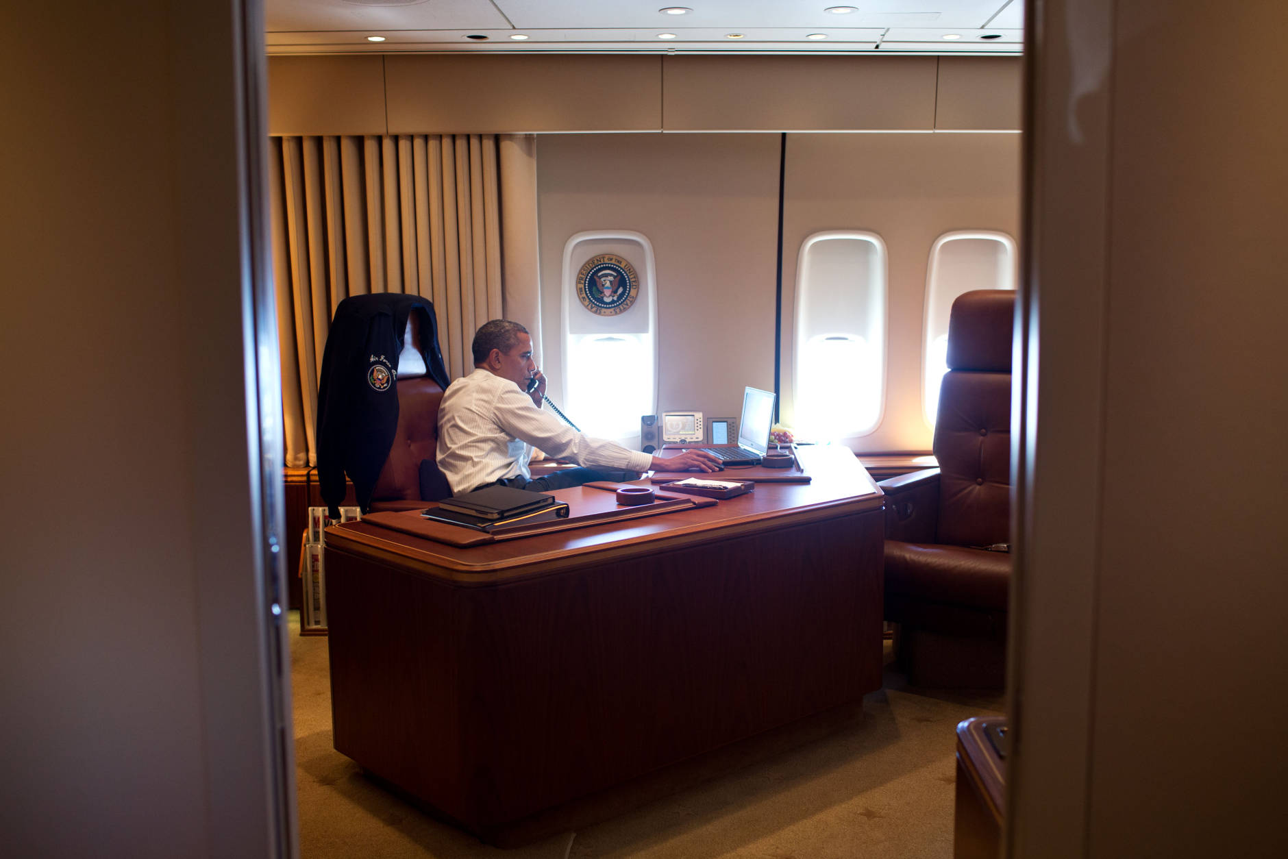 President Barack Obama holds a conference call with advisors aboard Air Force One during a flight to Portland, Ore., July 24, 2012. (Official White House Photo by Pete Souza)

This official White House photograph is being made available only for publication by news organizations and/or for personal use printing by the subject(s) of the photograph. The photograph may not be manipulated in any way and may not be used in commercial or political materials, advertisements, emails, products, promotions that in any way suggests approval or endorsement of the President, the First Family, or the White House.Ê