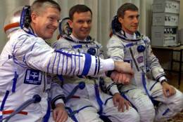 Russian cosmonauts Sergei Krikalyov, right, Yuri Gidzenko and U.S. astronaut Bill Shepherd, left, pose before launching at the Baikonur cosmodrome, Tuesday, Oct. 31, 2000. They became the first residents of the international space station, christening it Alpha on Nov. 2, 2000. (AP Photo/Pool)