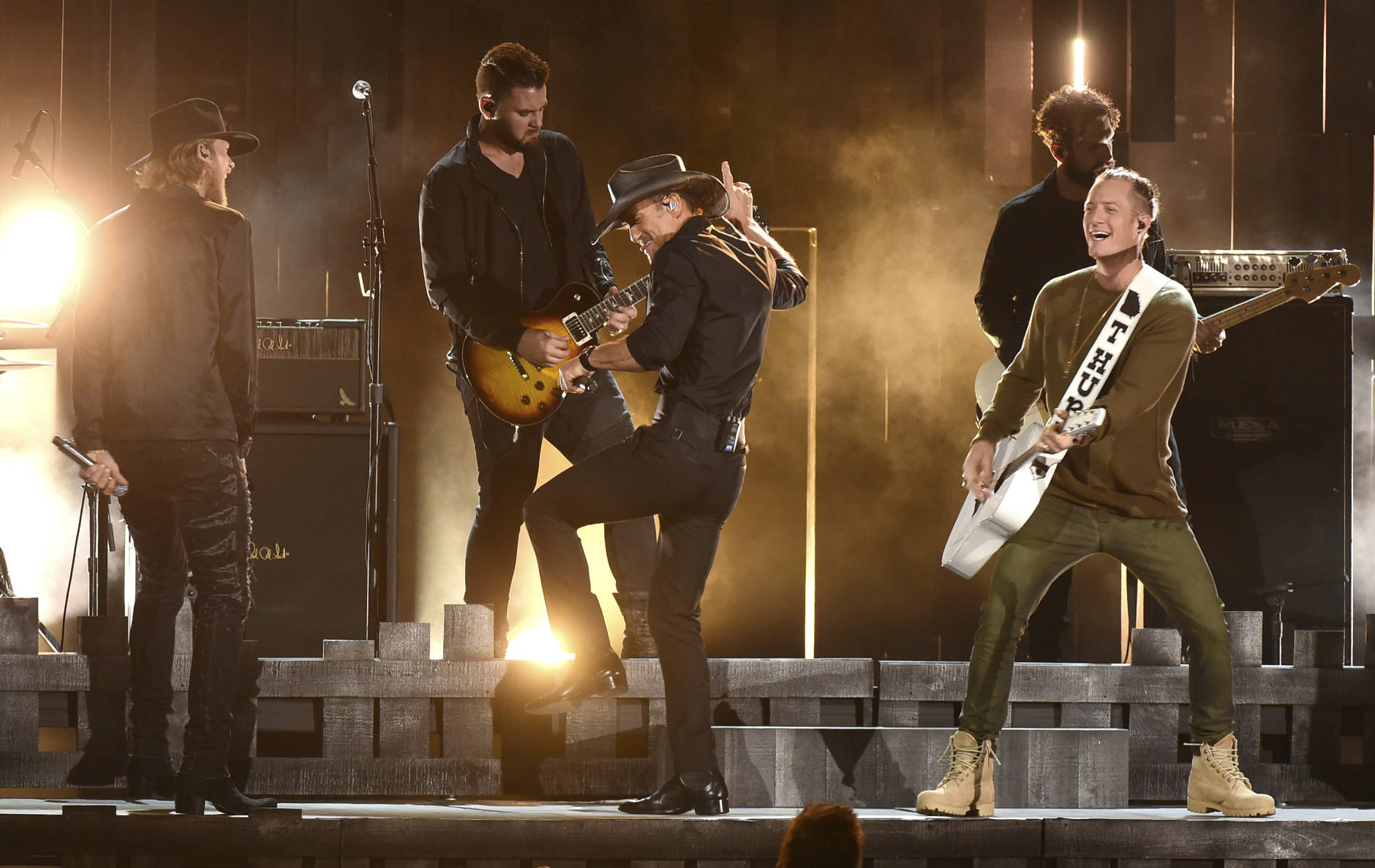 Tim McGraw, center, Brian Kelley, left, and Tyler Hubbard, right, of Florida Georgia Line, perform at the 50th annual CMA Awards at the Bridgestone Arena on Wednesday, Nov. 2, 2016, in Nashville, Tenn. (Photo by Charles Sykes/Invision/AP)