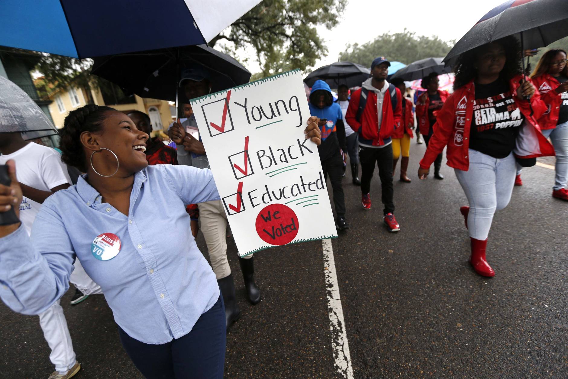 Mariah Hickman, a Dillard University student march in unison with fellow students, to a polling place to vote on election day in New Orleans, Tuesday, Nov. 8, 2016. (AP Photo/Gerald Herbert)