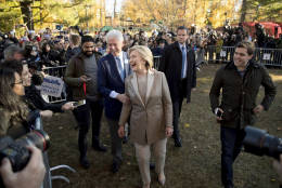 Democratic presidential candidate Hillary Clinton, center, accompanied by her husband, former President Bill Clinton, center left, greets supporters outside Douglas G. Grafflin School in Chappaqua, N.Y., Tuesday, Nov. 8, 2016, after voting. (AP Photo/Andrew Harnik)