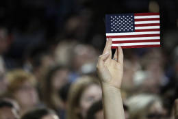 A small American flag is held aloft during Democratic presidential nominee Hillary Clinton's election night rally in the Jacob Javits Center glass enclosed lobby in New York, Tuesday, Nov. 8, 2016. (AP Photo/Frank Franklin II)