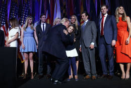 President-elect Donald Trump bends down to kiss his granddaughter Arabella Kushner during an election night rally, Wednesday, Nov. 9, 2016, in New York. (AP Photo/ Evan Vucci)
