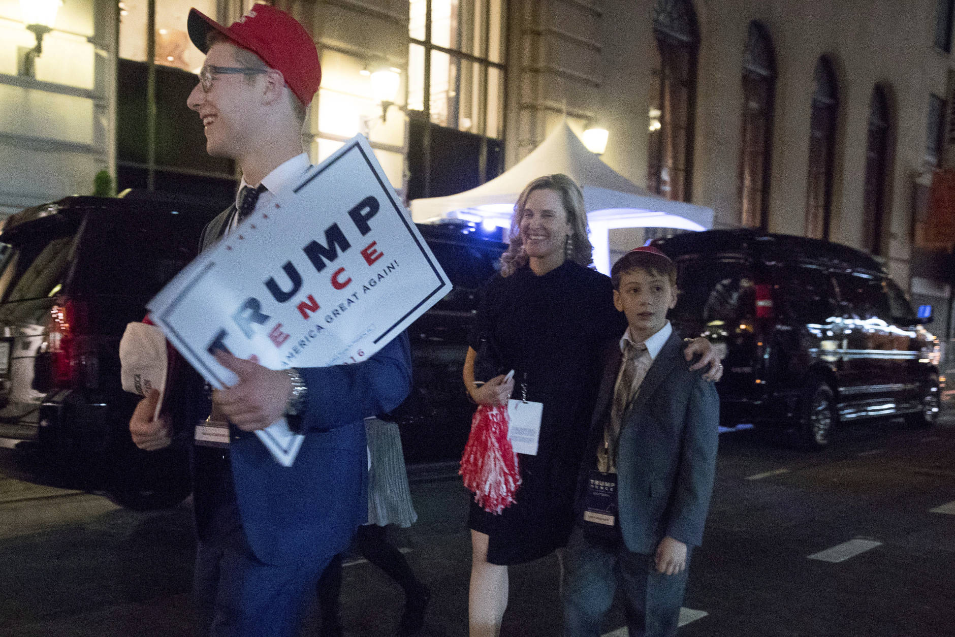Supporters of President-elect Donald Trump walk past Hillary Clinton's motorcade outside at The Peninsula Hotel in New York, Wednesday, Nov. 9, 2016, after Clinton concedes the election to Donald Trump. (AP Photo/Andrew Harnik)