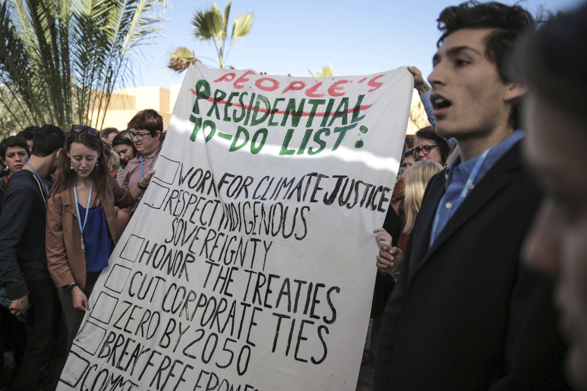 Environmental activists hold a banner during a protest against President-elect Donald Trump at the Climate Conference, known as COP22, in Marrakech, Morocco, Wednesday, Nov. 9, 2016. The election of a U.S. president who has called global warming a "hoax" alarmed environmentalists and climate scientists and raised questions about whether America, once again, would pull out of an international climate deal. (AP Photo/Mosa'ab Elshamy)