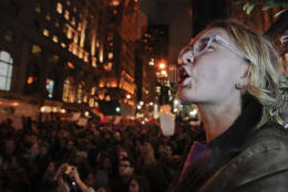 A protester chants slogans along with a crowd gathered outside Trump Tower in Fifth Avenue, Wednesday, Nov. 9, 2016, in New York, in opposition of Donald Trump's presidential election victory. (AP Photo/Julie Jacobson)