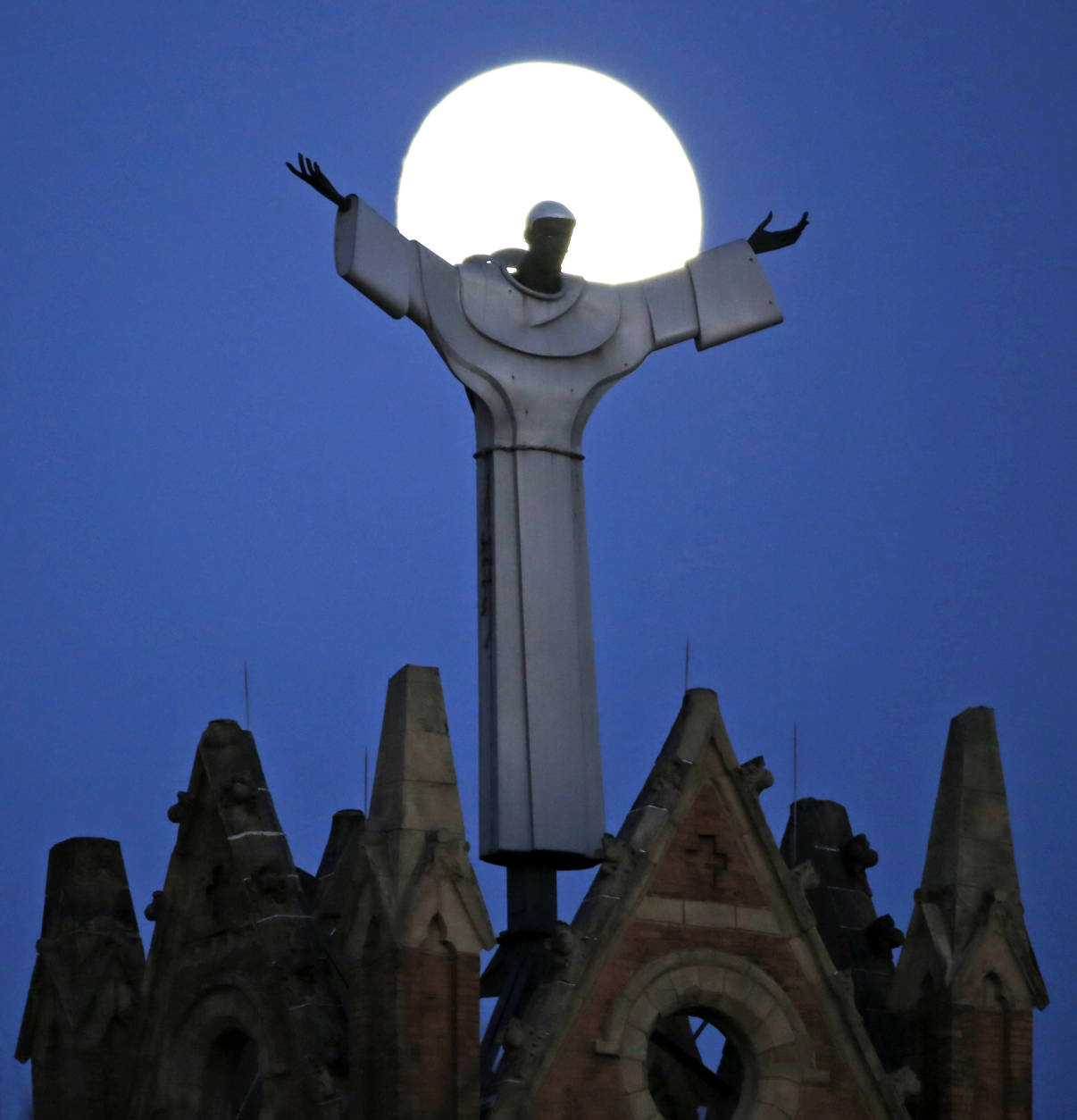 The moon rises behind St. Benedict The Moor Catholic church in Pittsburgh Saturday, Nov. 12, 2016. The Supermoon on November 14, 2016, will be the closest a Full Moon has been to Earth since January 26, 1948. The next time a Full Moon is even closer to Earth will be on November 25, 2034. (AP Photo/Gene J. Puskar)