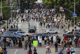 Anti-Trump protestors march through a street during a rally in downtown Los Angeles on Saturday, Nov. 12, 2016, to protest against President-elect Donald Trump. (AP Photo/Damian Dovarganes)