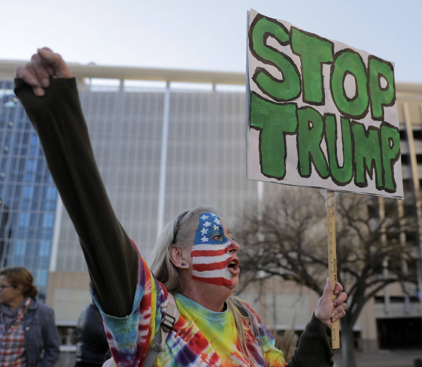 Mary Johnson protests against the election of President-elect Donald Trump Saturday, Nov. 12, 2016, in front of City Hall in Kansas City, Mo. (AP Photo/Charlie Riedel)