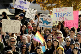 People protest against the election of President-elect Donald Trump Saturday, Nov. 12, 2016, in front of City Hall in Kansas City, Mo. Thousands took to the streets Saturday across the United States as demonstrations against Trump continued in New York, Chicago, Los Angeles and beyond. (AP Photo/Charlie Riedel)