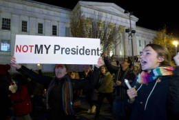 A demonstrator holds a banner as they protest during a march in downtown Washington in opposition of President-elect Donald Trump, on Saturday, Nov. 12, 2016. More than 200 people, carrying signs, gathered on the steps of the Washington state Capitol. The group chanted "not my president" and "no Trump, no KKK, no fascist USA." ( AP Photo/Jose Luis Magana)