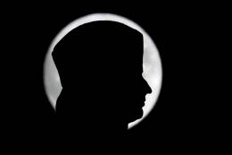 The moon is seen in its waxing gibbous stage behind the head of the Christopher Columbus statue at Columbus Circle, Sunday, Nov. 13, 2016, in New York. (AP Photo/Julio Cortez)