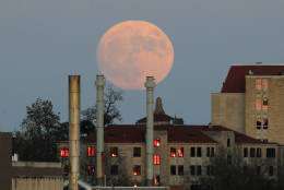 The moon rises beyond the University of Kansas campus in Lawrence, Kan., Sunday, Nov. 13, 2016. The morning's supermoon will be the closest a full moon has been to Earth since Jan. 26, 1948. (AP Photo/Orlin Wagner)