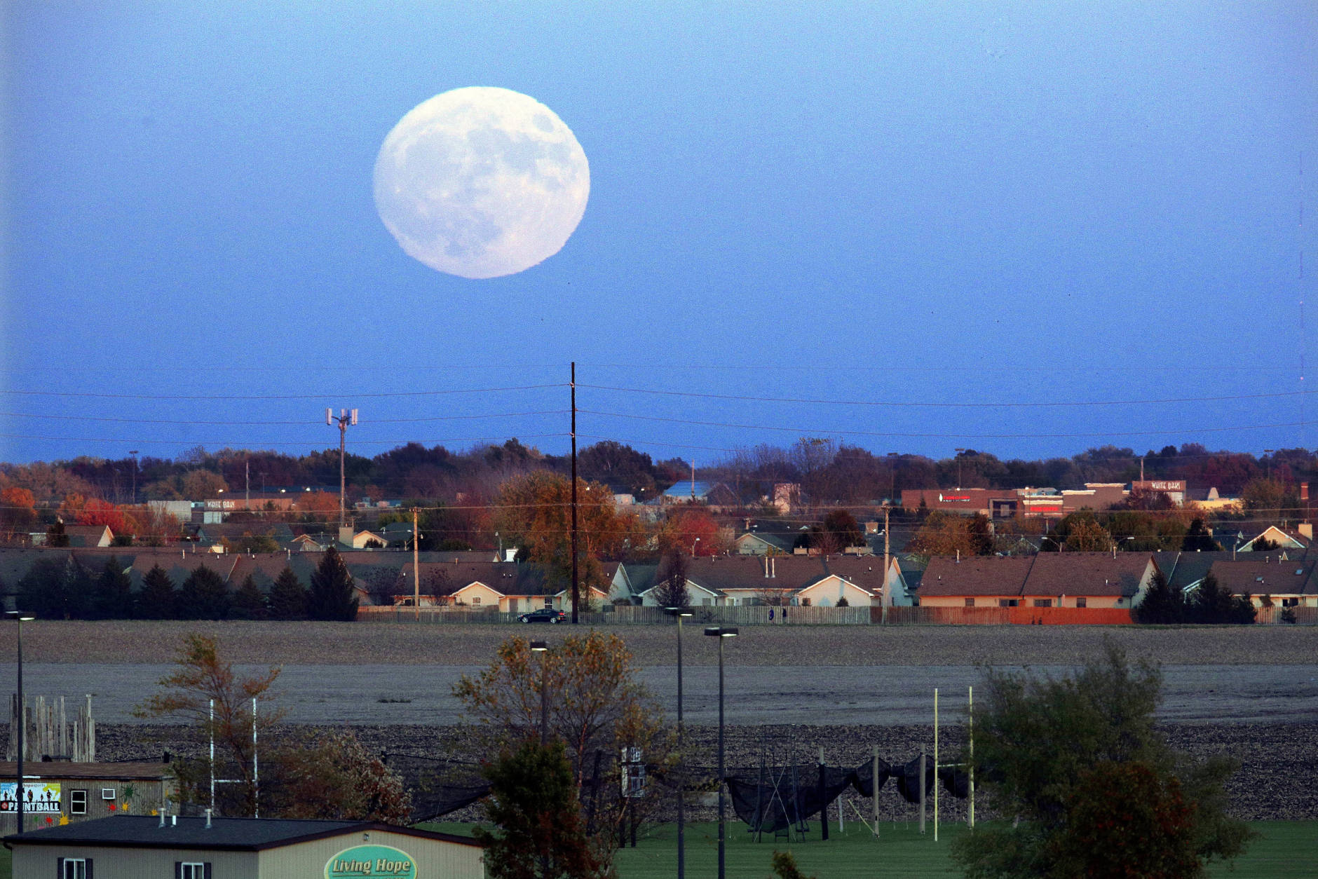 The moon rises beyond Springfield, Ill., Sunday, Nov. 13, 2016. On Monday the supermoon will be the closest full moon to earth since 1948, and it won't be as close again until 2034. (AP Photo/Seth Perlman)