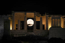 The moon rises behind the Propylaia at the Acropolis hill in Athens, Monday, Nov. 14, 2016.  The brightest moon in almost 69 years will be lighting up the sky this week in a treat for star watchers around the globe. (AP Photo/Yorgos Karahalis)