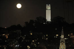 The moon rises over Coit Tower, at right, in San Francisco, Monday, Nov. 14, 2016. The brightest moon in almost 69 years is lighting up the sky in a treat for star watchers around the globe. The phenomenon known as the supermoon reached its peak luminescence in North America before dawn on Monday. Its zenith in Asia and the South Pacific was Monday night. (AP Photo/Marcio Jose Sanchez)