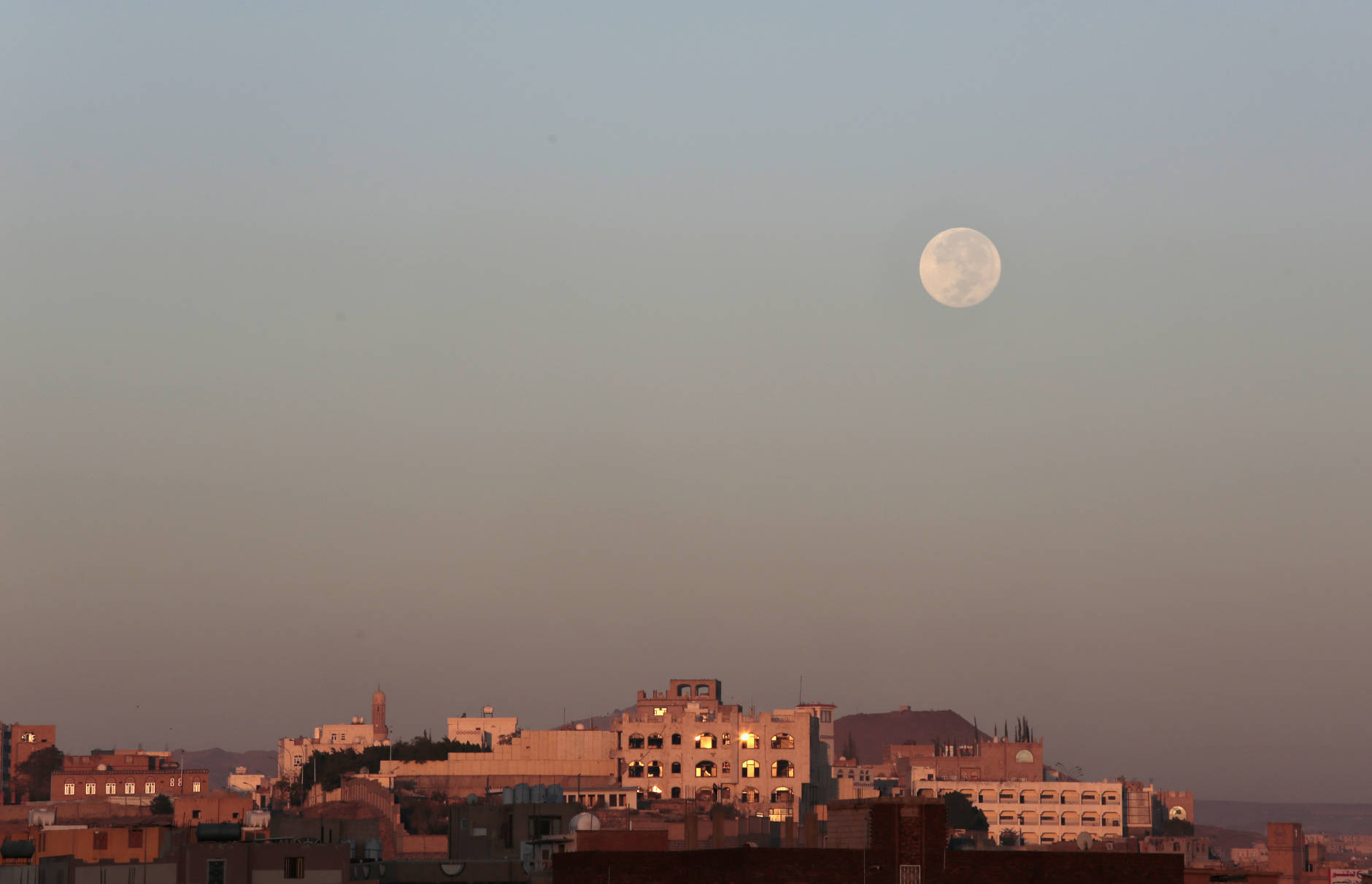 The moon is seen over the capital Sanaa, Yemen, Tuesday, Nov. 15, 2016. The brightest moon in almost 69 years lit up the sky, during its closest approach to earth as the "Supermoon" reached its most luminescent phase. The moon won't be this close again until Nov. 25, 2035. (AP Photo/Hani Mohammed)