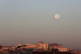 The moon is seen over the capital Sanaa, Yemen, Tuesday, Nov. 15, 2016. The brightest moon in almost 69 years lit up the sky, during its closest approach to earth as the "Supermoon" reached its most luminescent phase. The moon won't be this close again until Nov. 25, 2035. (AP Photo/Hani Mohammed)