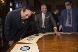 Gershwin Prize recipient Smokey Robinson looks at items in a special display with Berry Gordy Jr., founder of Motown Record Label, and Matt Barton, curator for recorded sound at the Library of Congress, while visiting the Library in Washington, Tuesday, Nov. 15, 2016. (AP Photo/Molly Riley)
