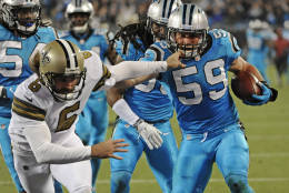 Carolina Panthers' Luke Kuechly (59) runs past New Orleans Saints' Thomas Morstead (6) as he returns a blocked field goal attempt in the first half of an NFL football game in Charlotte, N.C., Thursday, Nov. 17, 2016. (AP Photo/Mike McCarn)