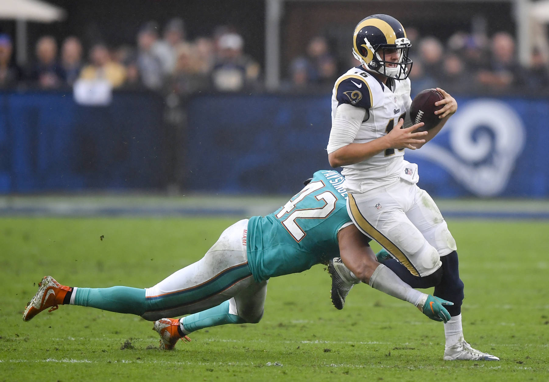 Los Angeles Rams quarterback Jared Goff, right, is tackled by Miami Dolphins linebacker Spencer Paysinger during the second half of an NFL football game Sunday, Nov. 20, 2016, in Los Angeles. (AP Photo/Mark J. Terrill)