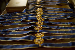 Presidential Medals of Freedom are seen on a table prior to the start of the ceremony in the East Room of the White House Washington, Tuesday, Nov. 22, 2016, where President Barack Obama is recognizing 21 Americans with the nation's highest civilian award, including giants of the entertainment industry, sports legends, activists and innovators. (AP Photo/Pablo Martinez Monsivais)