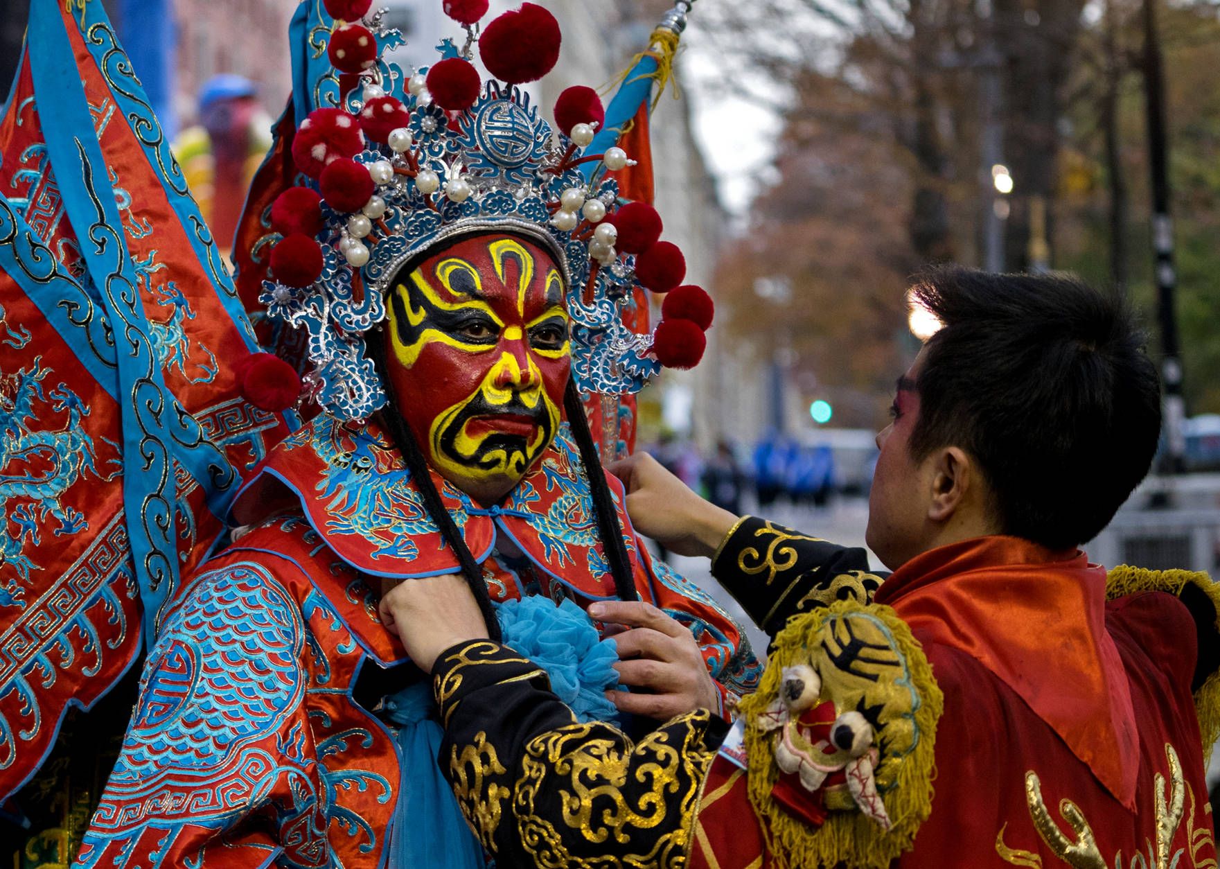 A dancer with the Chengdu (China) Panda float is assisted by a fellow dancer before the start of the Macy's Thanksgiving Day Parade in New York, Thursday, Nov. 24, 2016. (AP Photo/Craig Ruttle)