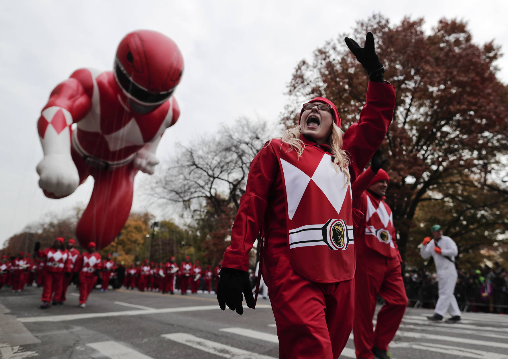 A balloon operator waves to spectators while guiding the Red Ranger balloon along West Central Park during the Macy's Thanksgiving Day parade, Thursday, Nov. 24, 2016, in New York. (AP Photo/Julie Jacobson)