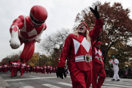 A balloon operator waves to spectators while guiding the Red Ranger balloon along West Central Park during the Macy's Thanksgiving Day parade, Thursday, Nov. 24, 2016, in New York. (AP Photo/Julie Jacobson)