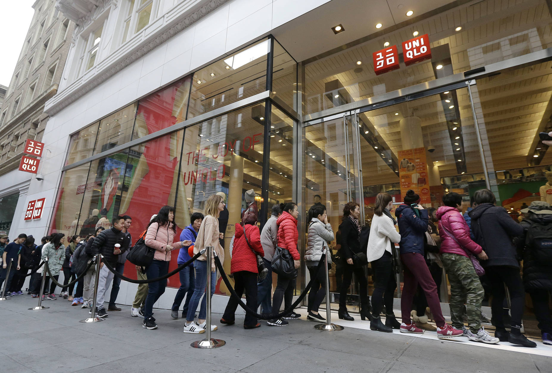 Shoppers wait in line to enter a Uniqlo store as it opens in San Francisco, Friday, Nov. 25, 2016. Black Friday, historically the starting line of the retail industry's crucial holiday buying season, isn't quite the one-day spree it used to be. Some retailers have pushed their biggest Black Friday door-buster deals into Thanksgiving Day and spread other promotions to even earlier in the season. (AP Photo/Jeff Chiu)