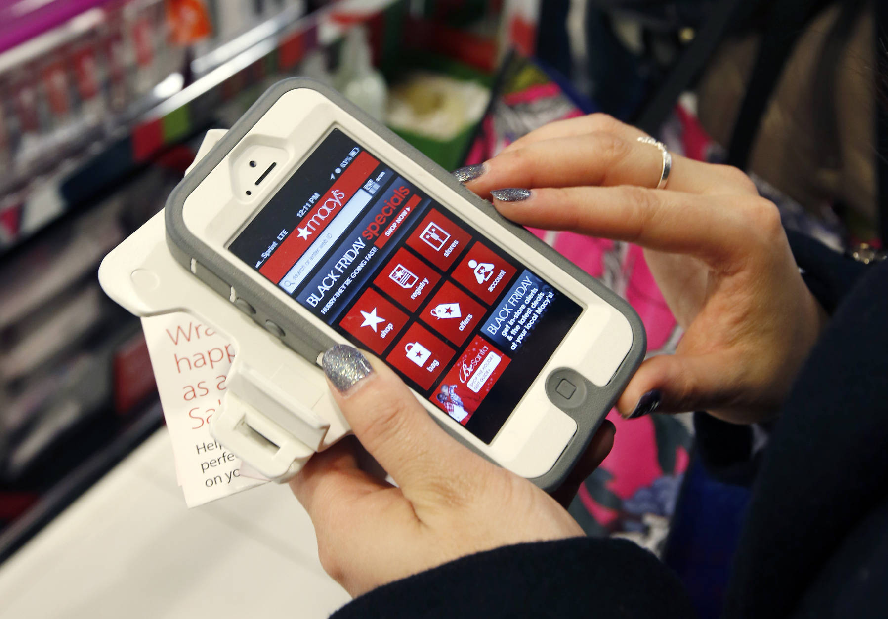 Smartphone apps can help shoppers find coupons, compare prices or price match.  (AP Photo/Michael Dwyer)