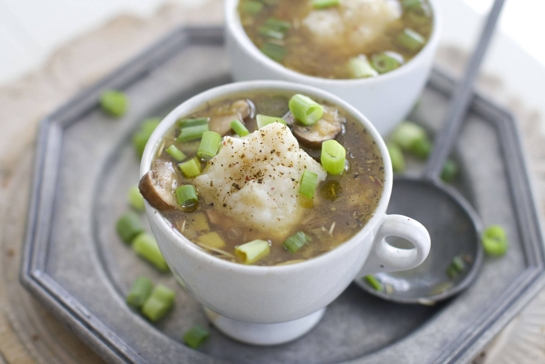 In this image taken on Sept. 17, 2012, cups of Mushroom and Chicken Barley Soup with Parmesan Dumplings are shown in Concord, N.H. (AP Photo/Matthew Mead)