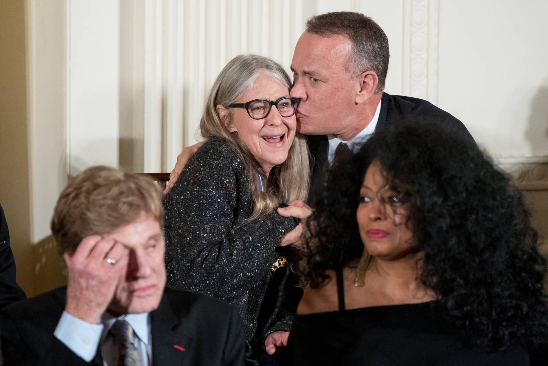 Mathematician and computer scientist Margaret Hamilton gets a kiss from actor Tom Hanks, right, after she receives the Presidential Medal of Freedom from President Barack Obama during a ceremony in the East Room of the White House, Tuesday, Nov. 22, 2016, in Washington. Obama is recognizing 21 Americans with the nation's highest civilian award, including giants of the entertainment industry, sports legends, activists and innovators. (AP Photo/Andrew Harnik)