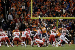 Kansas City Chiefs kicker Cairo Santos (5) kicks the game winning field goal as punter Dustin Colquitt (2) holds during overtime of an NFL football game against the Denver Broncos, Sunday, Nov. 27, 2016, in Denver. The Chiefs won 30-27 in overtime. (AP Photo/Jack Dempsey)