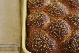 This Oct. 12, 2015, photo, shows sweet sesame dinner rolls in Concord, N.H. This recipe is a cross between an Italian scali bread, a light, tender bread crusted in sesame seeds, and a Portuguese sweet roll. (AP Photo/Matthew Mead)