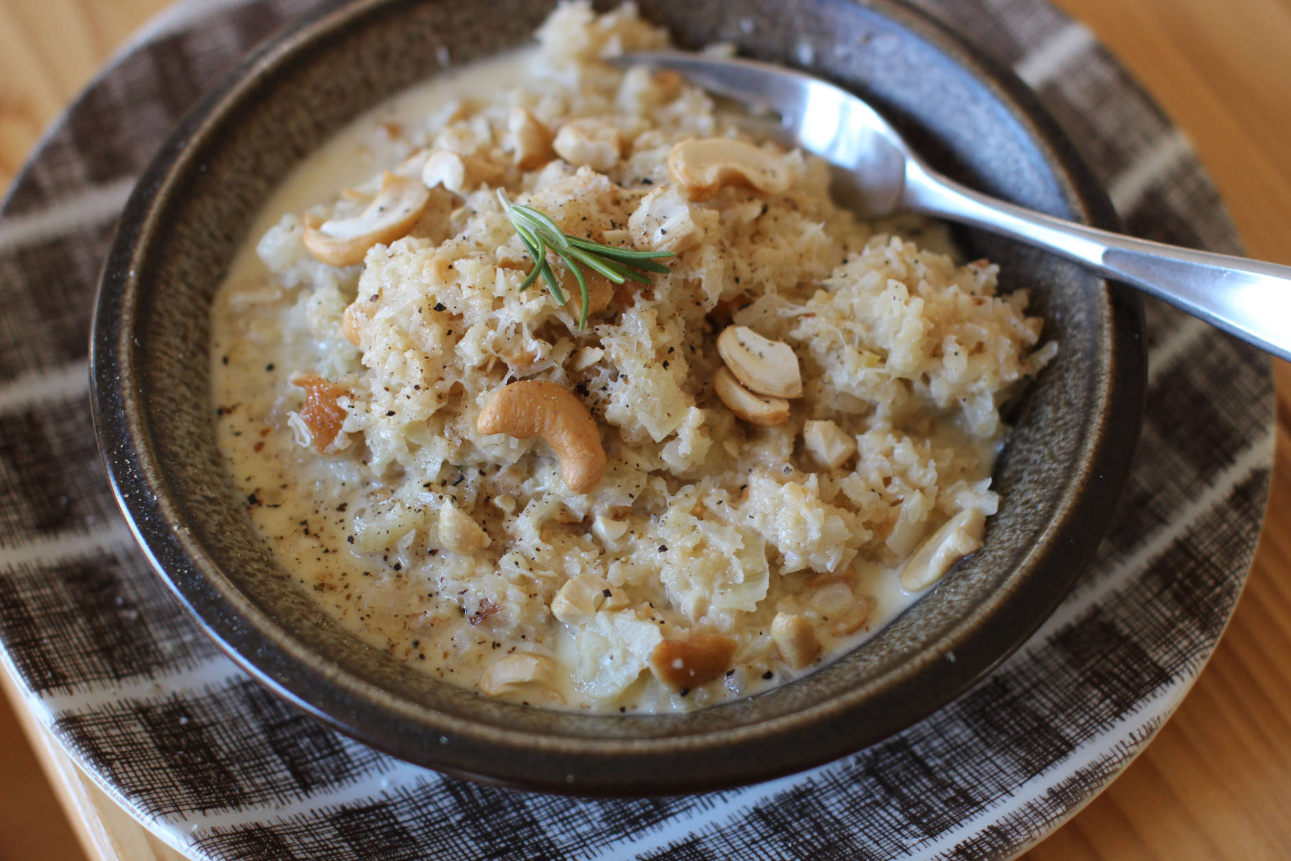 This Nov. 16, 2015 photo shows parmesan cashew cauliflower risotto in Concord, N.H. Transforming finely chopped cauliflower is so popular, grocers now sell bagged minced cauliflower labeled as ready to use in your favorite pizza crust and mashed potato-like recipes. (AP Photo/Matthew Mead)