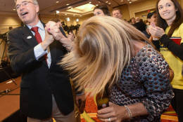 U.S. Rep. Andy Harris, left, a Maryland Republican running for re-election, high-fives supporter Debbie Peroutka, center, of Severna Park, Md., as his daughter, Rebecca Harris, right, 29, applauds during an election night party held by the Maryland Republican Party, Tuesday, Nov. 8, 2016 in Linthicum, Md. (AP Photo/Steve Ruark)
