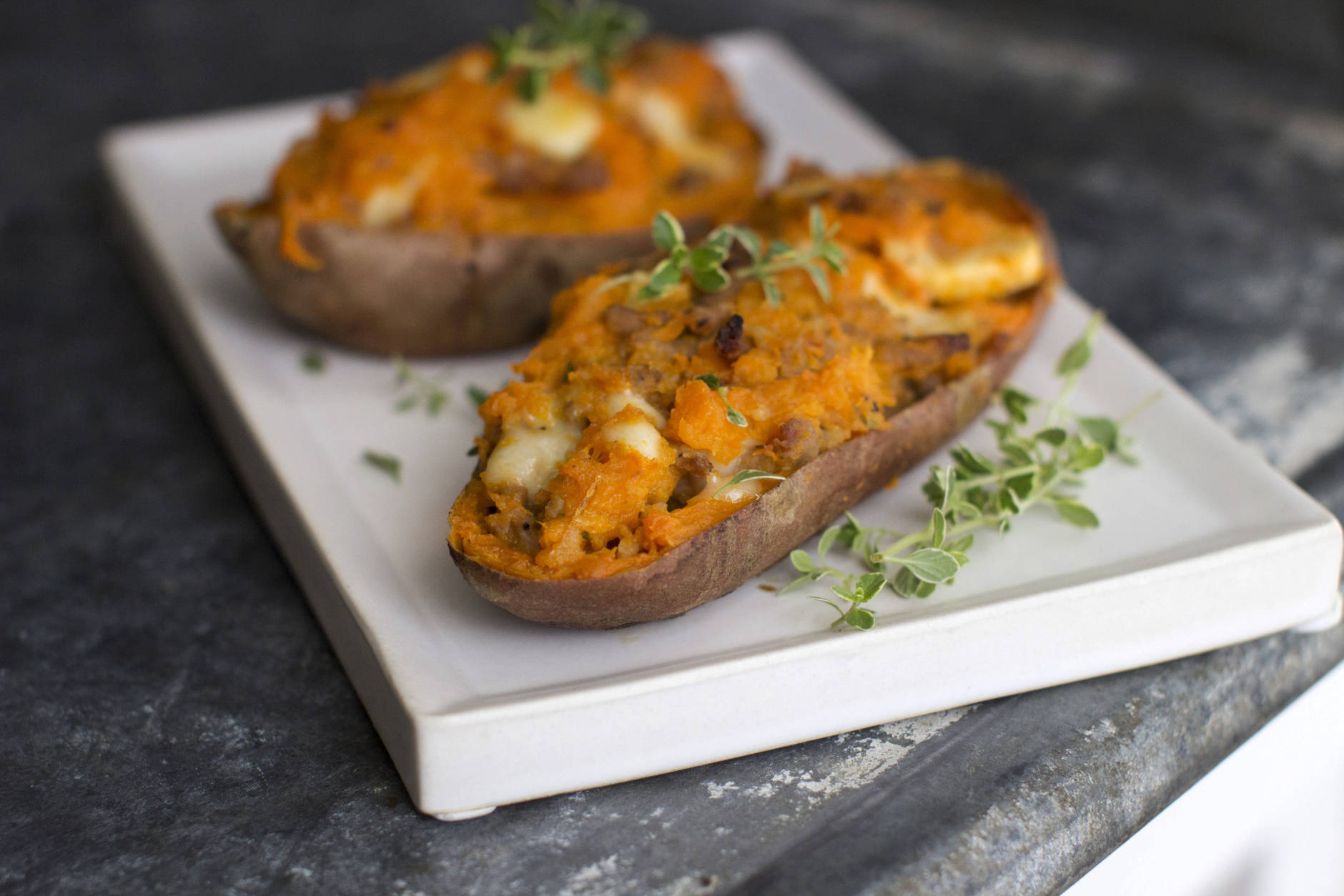 This July 28, 2014, photo shows apple-sausage stuffed twice-baked sweet potatoes in Concord, N.H. Add a bit of cheese to tie it all together and the meal takes just 20 minutes hands-on time. (AP Photo/Matthew Mead)