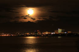 The supermoon rises over the Chugach Mountains on Monday, Nov. 14, 2016, in Anchorage, Alaska. The phenomenon known as the supermoon occurs because the moon follows an elliptical orbit around the Earth. This week, the moon is coming closer to the Earth than at any time since January 1948. (AP Photo/Dan Joling)