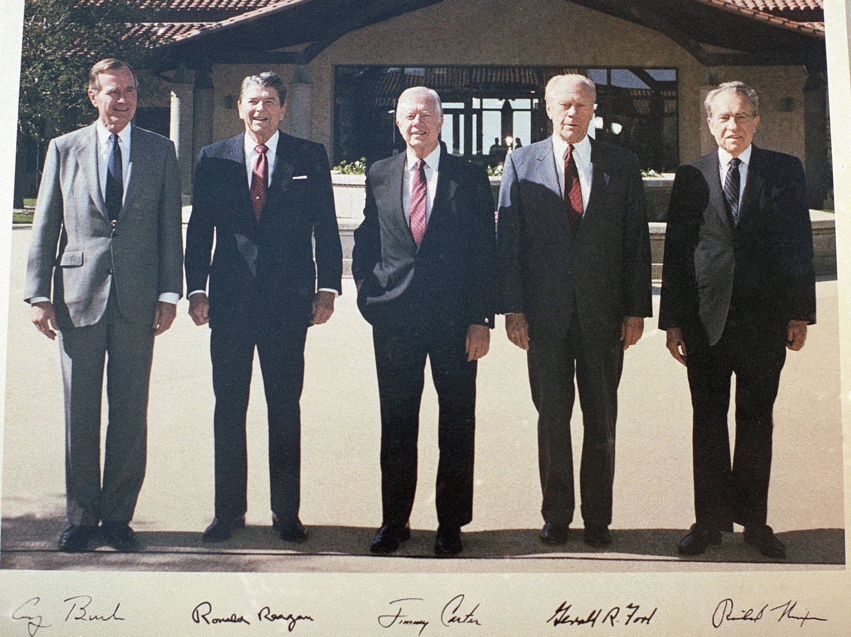 Former Presidents, from left, George H. W. Bush, Ronald Reagan, Jimmy Carter, Gerald Ford and Richard Nixon shown in the courtyard during the dedication of the Ronald Reagan Presidential Library in Simi Valley, Calif., on Nov. 4, 1991.  This photo was autographed by each of the heads of state. The five former presidents reportedly made a pact to sign only a limited number of photographs from the photo session in 1991, a deal that could net each up to $1.5 million. (AP Photo/Marcy Nighswander)