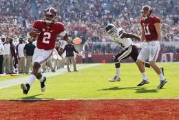 Alabama quarterback Jalen Hurts, left, scores a touchdown during the first half of an NCAA college football game against Mississippi State, Saturday, Nov. 12, 2016, in Tuscaloosa, Ala. (AP Photo/Brynn Anderson)